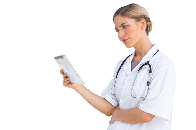 Confused nurse holding tablet pc