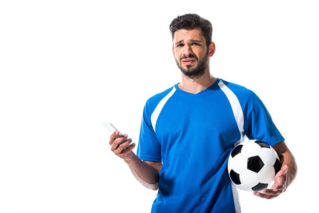 写真 スマートフォンを使用してボールと混乱したサッカー選手 isolated on white