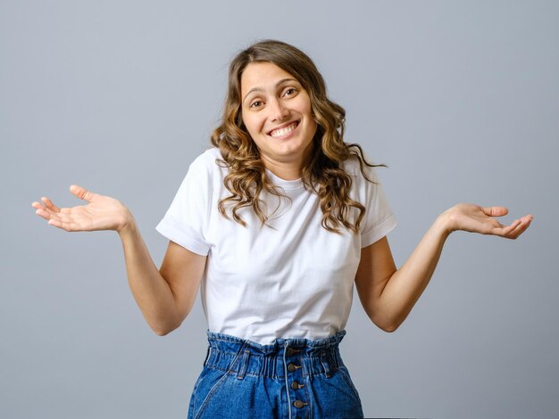 Confused woman spread hands sideways