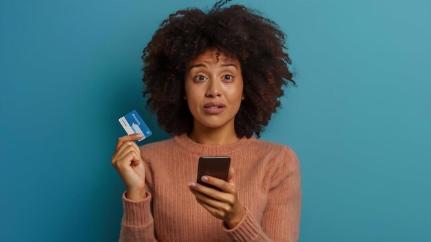 Confused woman staring at her smartphone and holding plastic credit card cant understand where mone