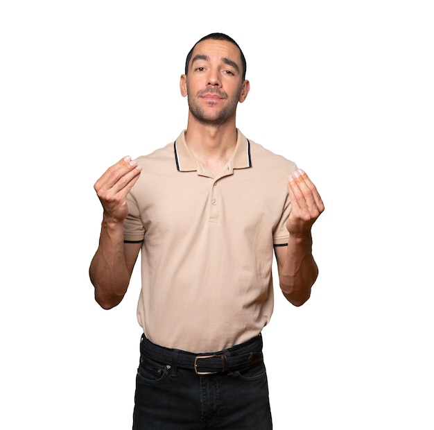 Confused young man making an italian gesture of not understanding