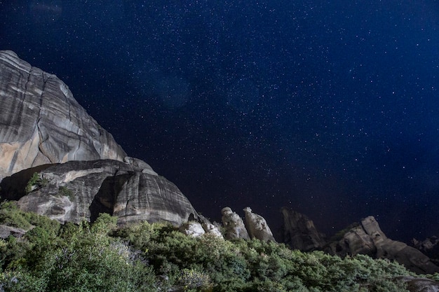 The conglomerate formation of Meteora during night dark sky with stars