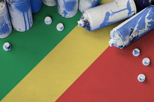 Congo flag and few used aerosol spray cans for graffiti painting Street art culture concept