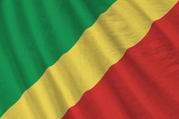 Congo flag with big folds waving close up under the studio light indoors The official symbols and colors in banner