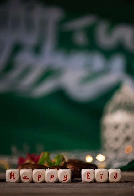 Congratulation HAPPY EID composed of wooden dices Saudi Arabian flag in the background