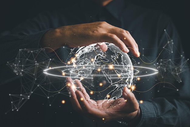 Connected in Digital Era Businessman hand holds globe illustrating interconnectedness facilitated by technology Big data analytics and business intelligence revolutionize global decision processes