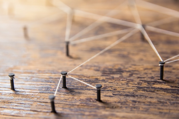 Connecting networks. Simulator network, social media, connected with yarn white on Plank wood 