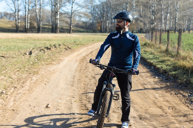 Conquering mountain peaks by cyclist in shorts and jersey on a modern carbon hardtail bike with an air suspension fork