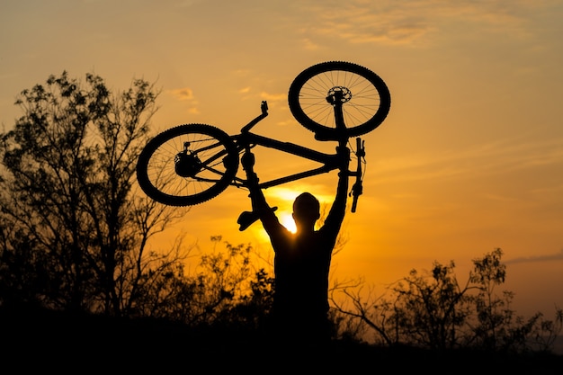 Conquering mountain peaks by cyclist in shorts and jersey on a modern carbon hardtail bike