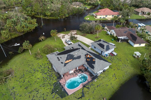 Consequences of natural disaster Heavy flood with high water surrounding residential houses after hurricane Ian rainfall in Florida residential area