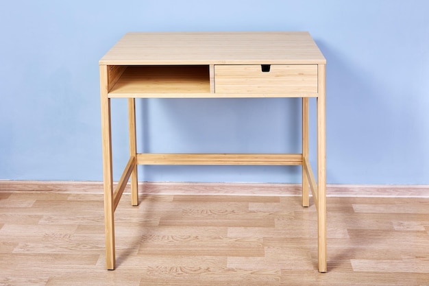 Console table with storage or writing desk against light blue\
wall in lounge room