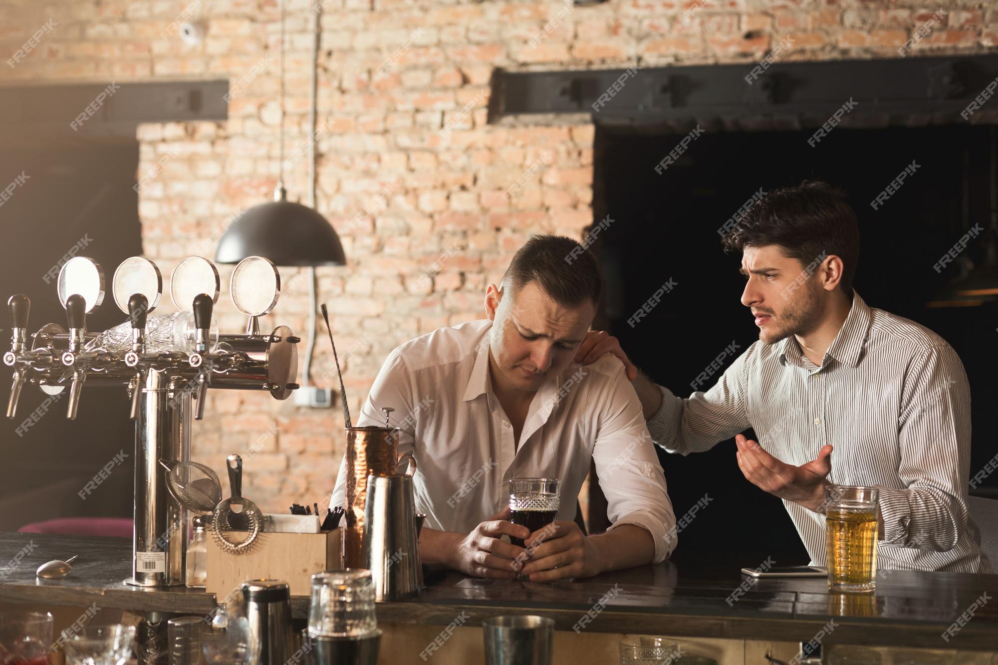 Premium Photo | Consoling his depressed friend. young stressed man sitting  at bar counter, being supported by his friend sitting near him,  relationship issues, copy space