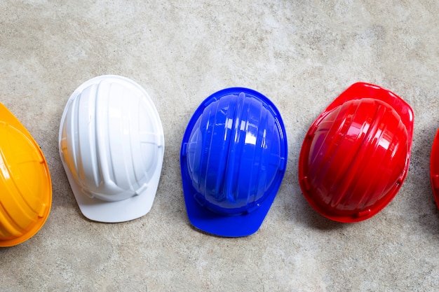 Constructi on helmets on concrete background