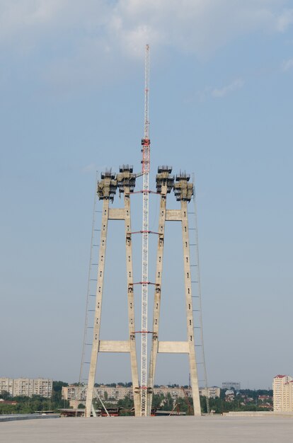 The construction of a bridge across the river with the supports, structural elements, cranes