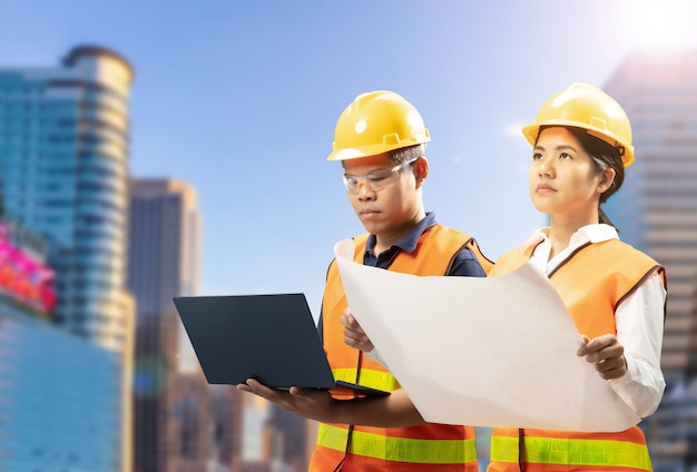 Construction business concept with civil engineer and cityscape background