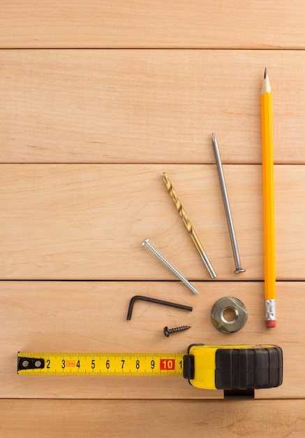 Construction concept on wooden wall