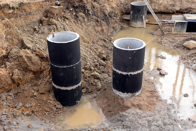 Construction concrete rings on the construction site a system of underground communications