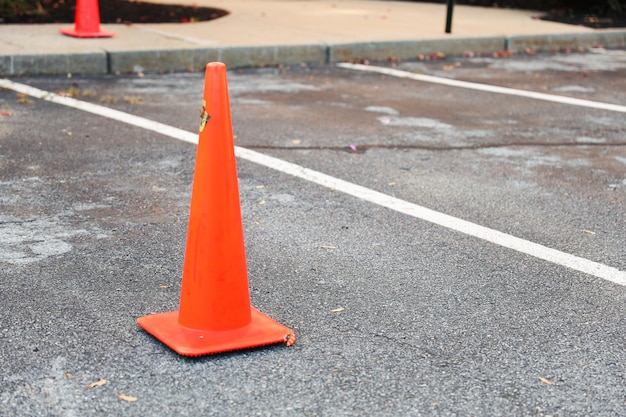 Construction cone on urban road representing safety work in progress and traffic control in a dyn