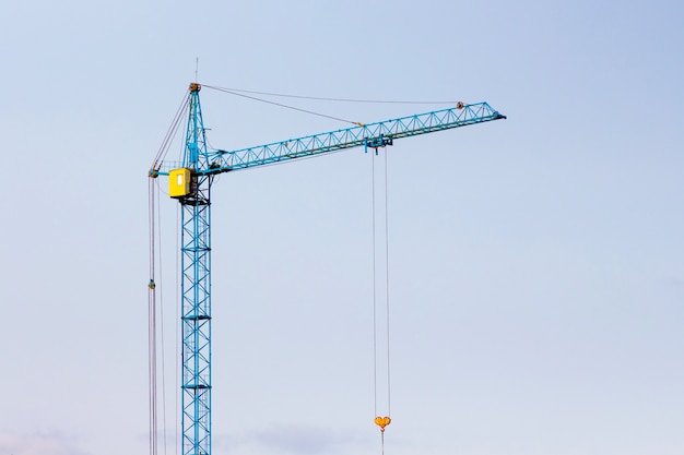 Construction crane against the blue sky