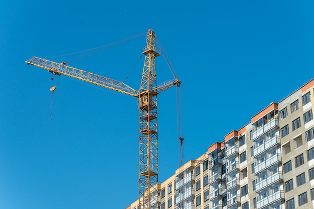 Construction crane near new built house