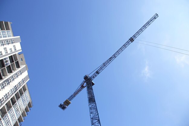 Construction crane and newly built high-rise residential building