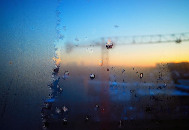 Construction crane through frozen window glass