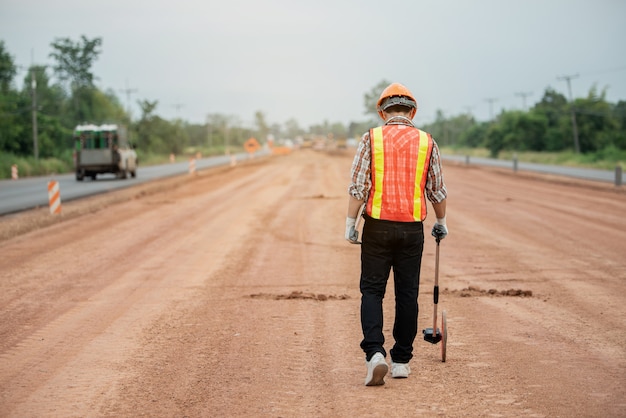 Construction engineer supervising work at construction site