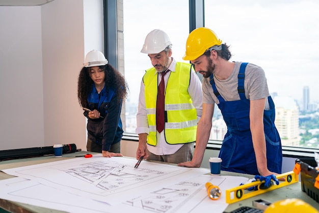 Construction engineer with foreman worker checking construction site