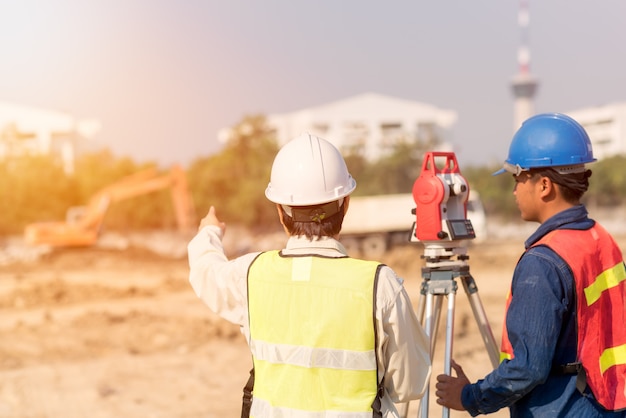 Construction engineer with foreman worker checking construction site