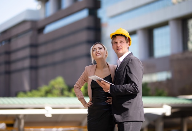 Construction engineers working and checking new project at a construction site