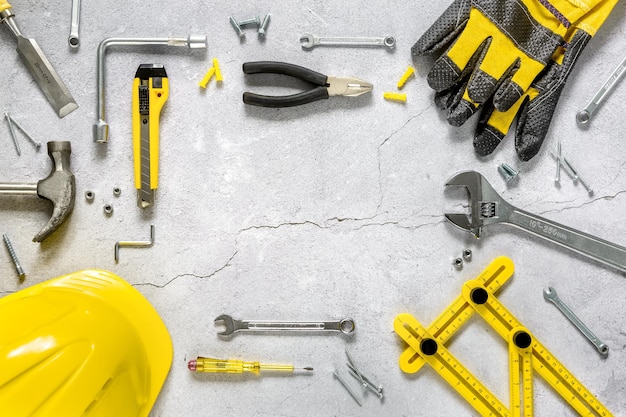 Photo construction equipment. repair tool kit. gray concrete background top view. space for text