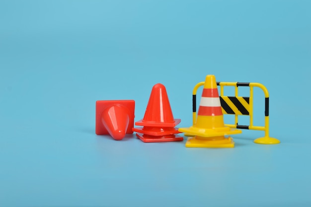 Construction fences and plastic cones isolated on a blue background