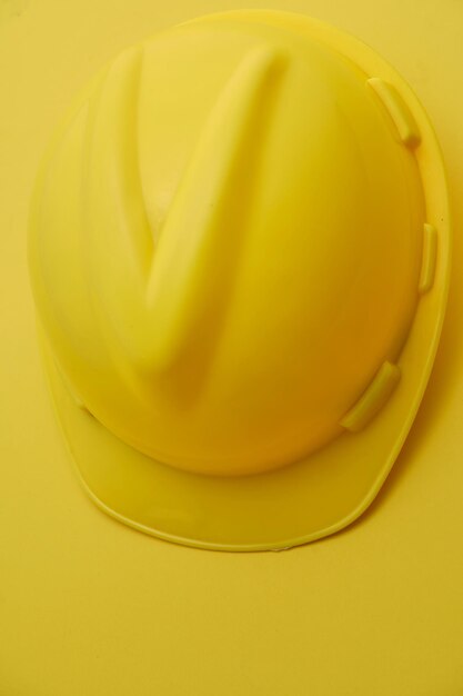 Photo construction hard hat on the yellow background