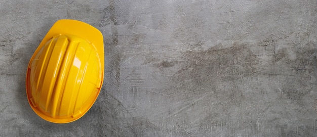 Construction helmet on concrete background.