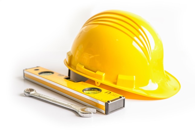 Construction helmet and tools for engineering work project on white background