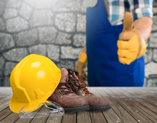 Construction industry protective safety equipment. Yellow hardhat or protective helmet,