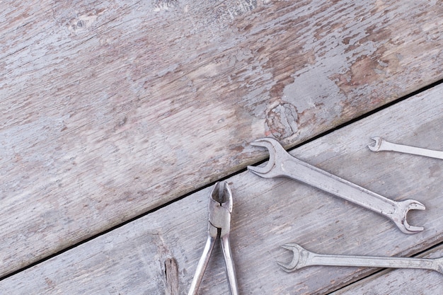 Construction instruments on rustic wooden background