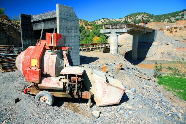 Construction machinery with bridge in background