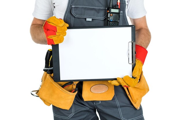A construction man showing a clean sheet of paper to the clipboard isolated on white background