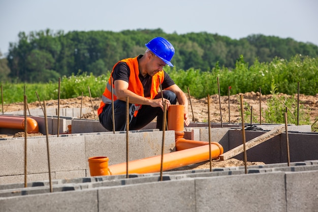 Construction manager checking the new bungalow foundation of the house, building concept