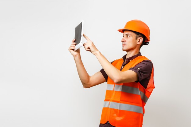 Construction manager controlling building site with plan