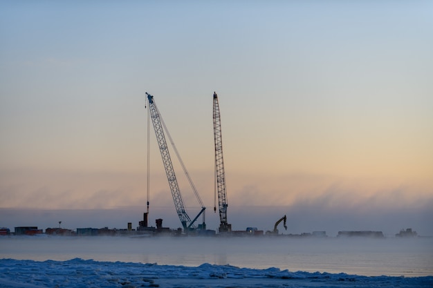 Construction Marine offshore works. Dam building, crane, barge, dredger. Breakwater construction.