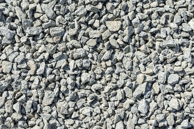 Construction materials for road works The texture of gray broken stone or rubble as a natural background