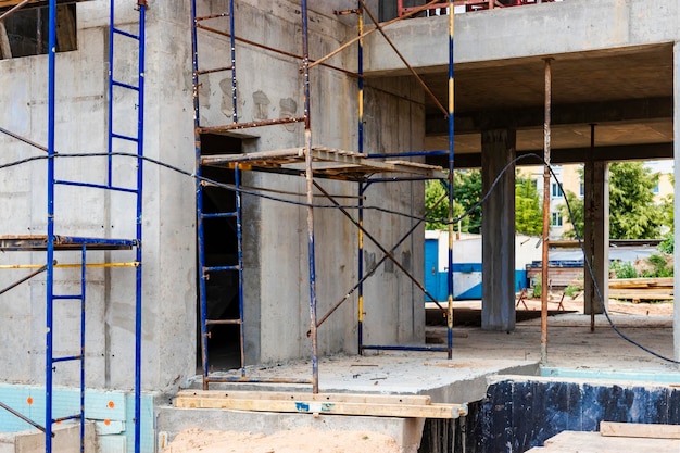 Construction of a new monolithic reinforced concrete house Formwork for pouring the next floor Working at height on a construction site