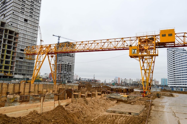 Construction of a new overpass in the city center tall yellow construction cranes are building