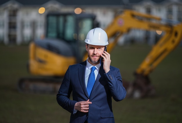 Construction owner near excavator confident construction owner in front of house architect civil