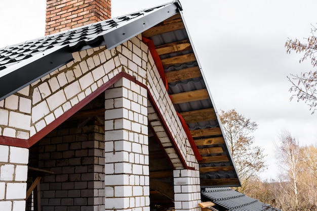 Construction of a pitched roof. Sheathing of metal roof. Roof slope.