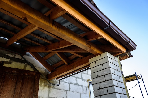 Construction of a pitched roof. Sheathing of metal roof. Roof slope.