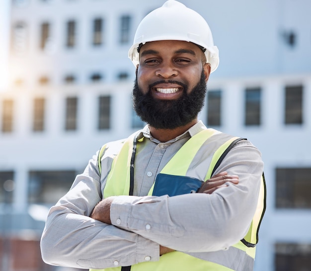 Construction portrait or man with arms crossed in city for building project site maintenance or civil engineering Architecture happy African professional contractor for urban property development