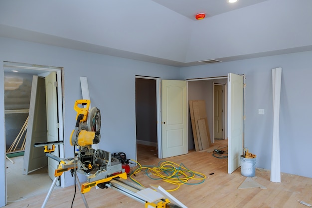 Photo construction remodeling home cutting wooden trim board on with circular saw.